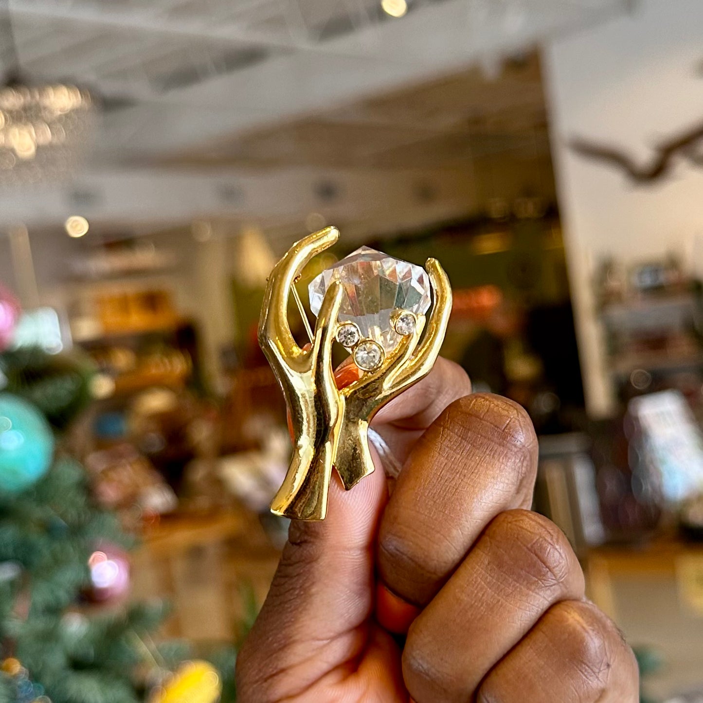 “Free People” Hands Holding Diamond Brooch